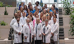 BMT team standing on stairs